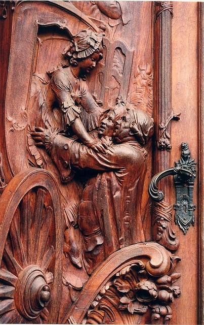 Photo:  A carved wooden door in Worms, Germany.